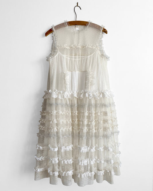 White lace dress on a hanger against a white background